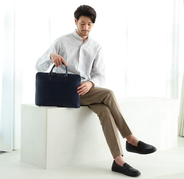 上質な革ビジネスバッグは、扱い方や所作まで変える  上質な本革のビジネスバッグは、美しい見た目から適当に扱うのがもったいなく感じるもの。自然とテーブルや床に置くときも静かに置くようになったり、カバンの中身を整理する習慣がついたりと、所作全体が自然と丁寧になっていきます。  また一つ丁寧な所作を身につけることでバッグだけでなく、書類や名刺入れ、PCまできちんと管理するようになり、ビジネスマナーそのものが一段レベルアップします。  特に所作を見られやすい営業先でバッグを取り出すときに、ガサガサと乱雑に取り出すのではなく、スッと取り出して静かに置く。そのたった数秒の動作が相手に与える印象は大きく変わります。 良いものを持つことで、扱い方・所作まで変わり、結果として信頼感へとつながっていきます。