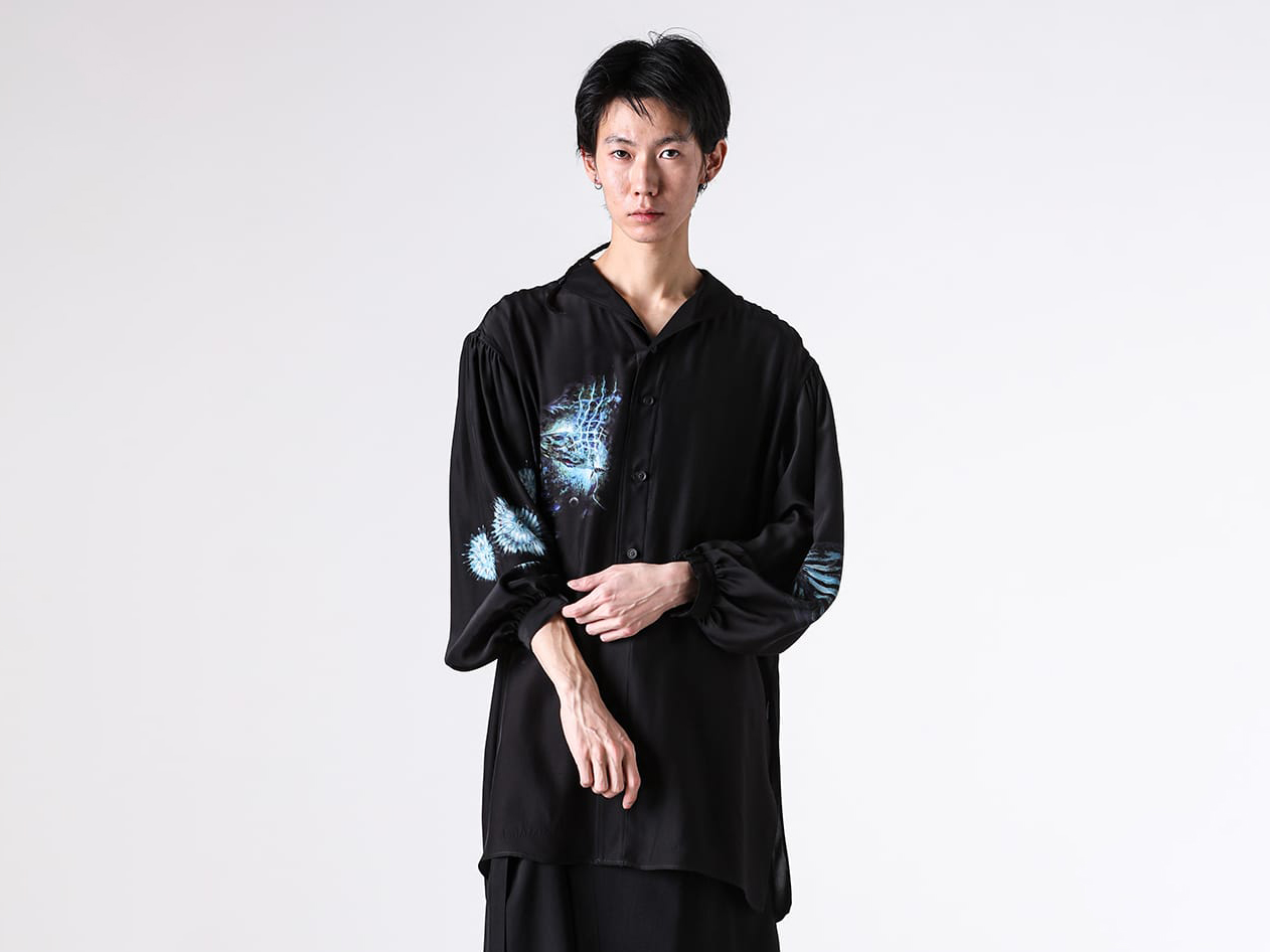 A close-up image of the blouse hanging on a hanger
