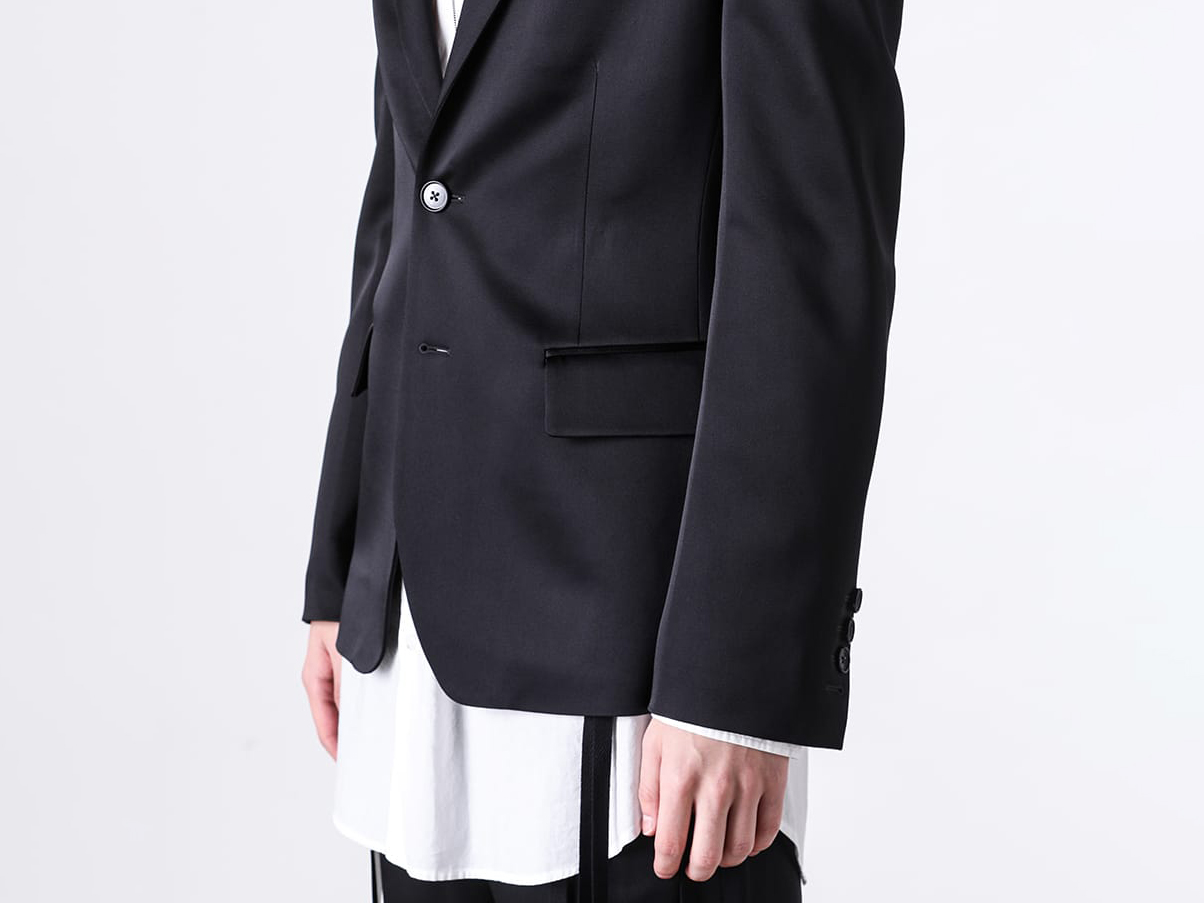 Close-up image of the jacket's lapel and welt chest pocket