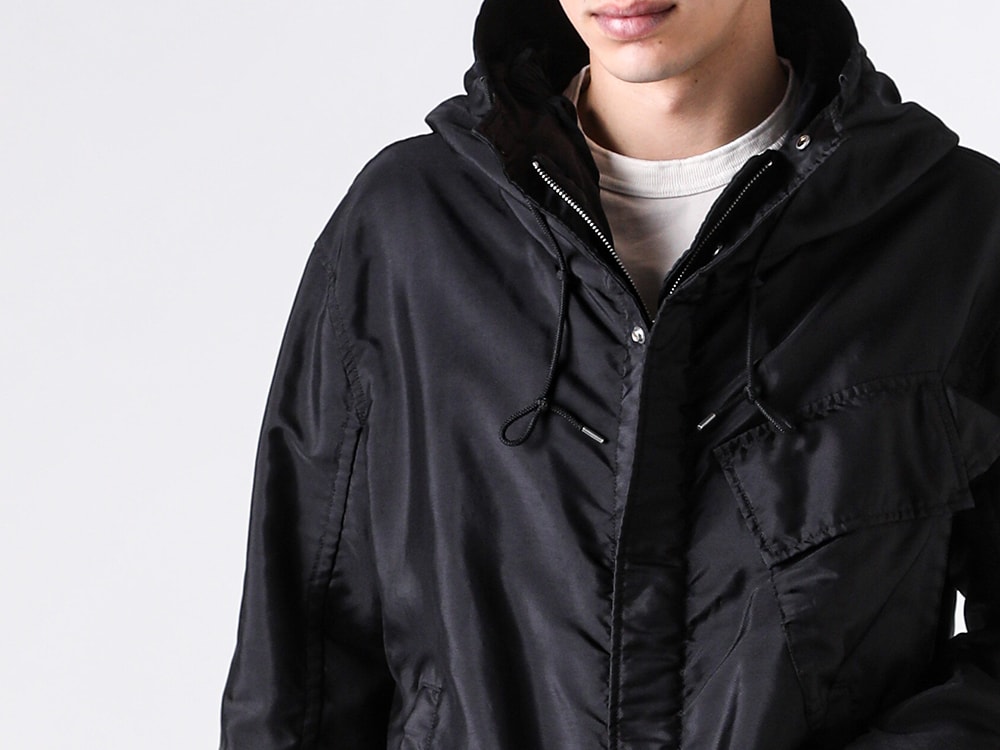 Close-up image of the front fly front construction of the Ten C FAIR ANORAK