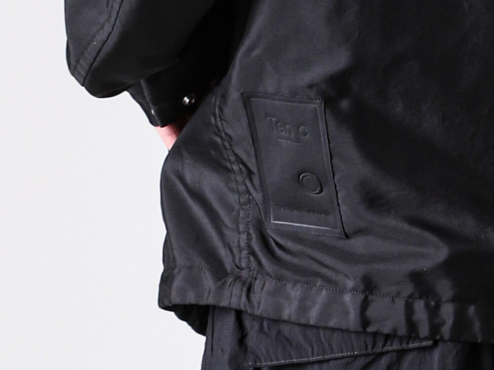 Rubber print logo image under the left arm of the Ten C FAIR ANORAK