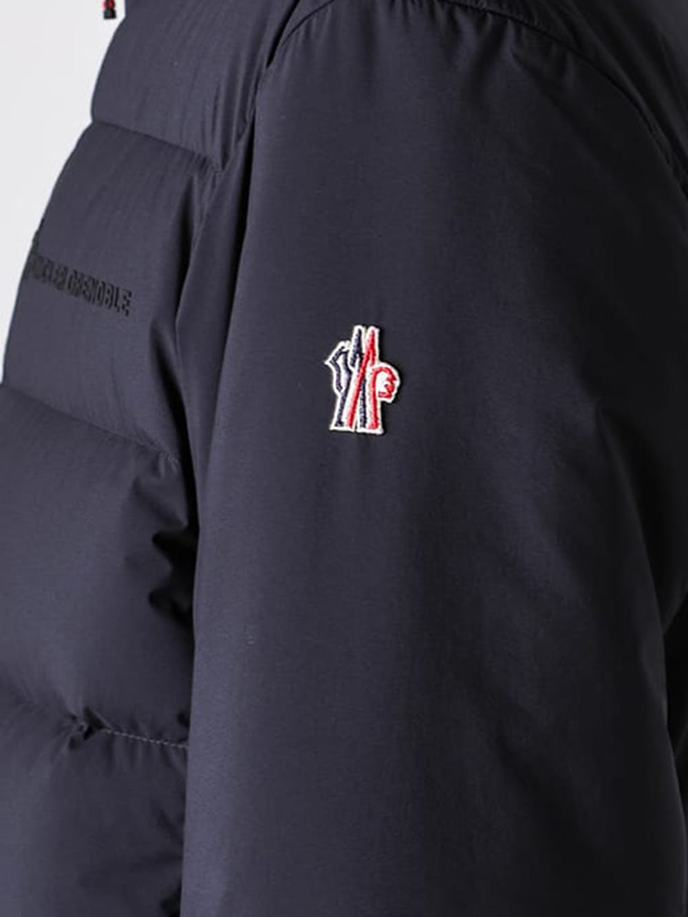 Close-up of the Moncler Grenoble brand logo