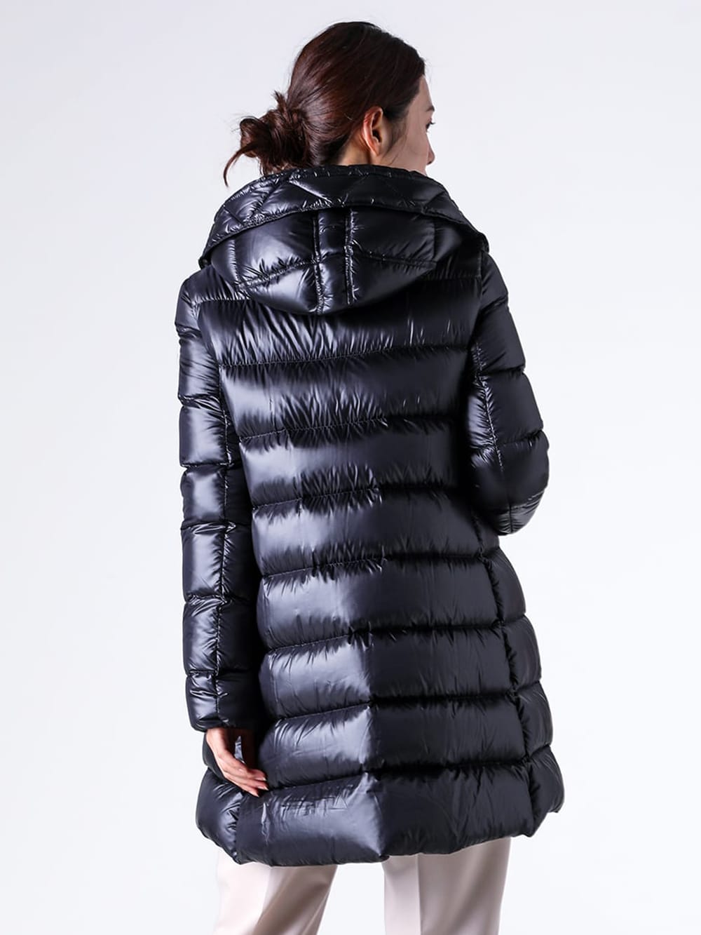 Close-up image of the fabric of a midi-length down jacket