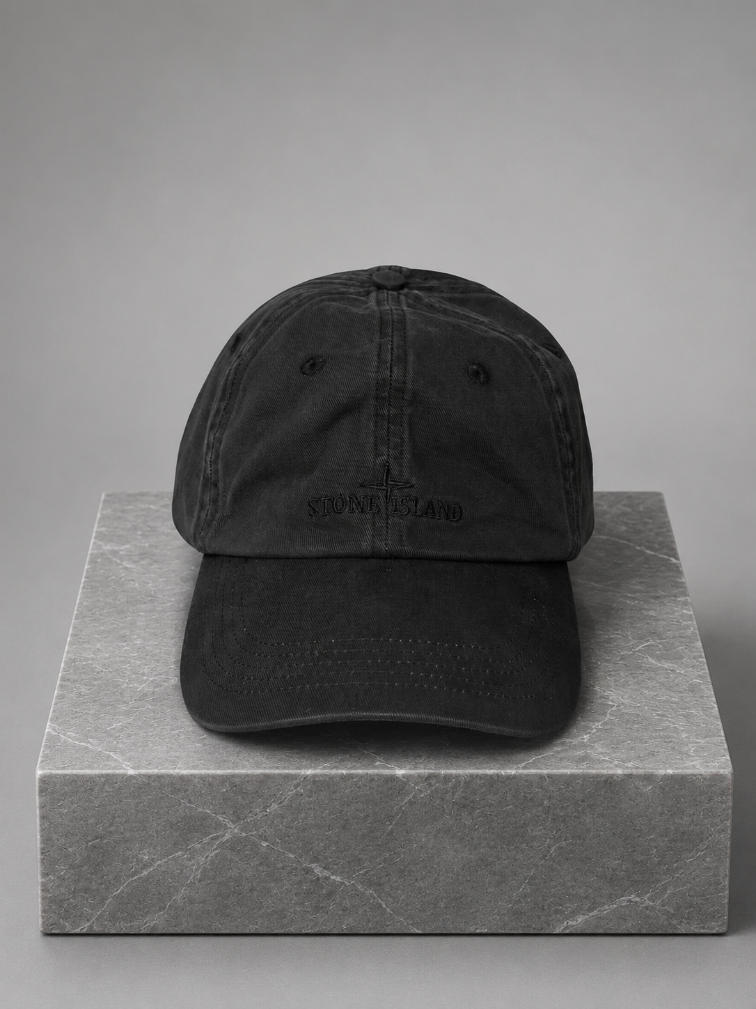 Image of a black baseball cap with logo embroidery on the front