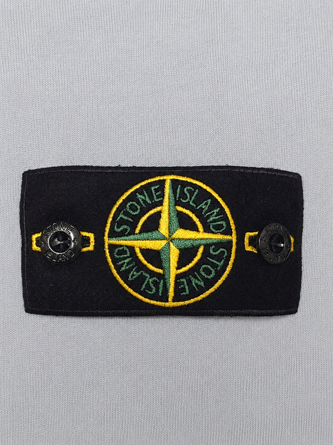 Close-up image of the iconic compass badge shining on the left arm