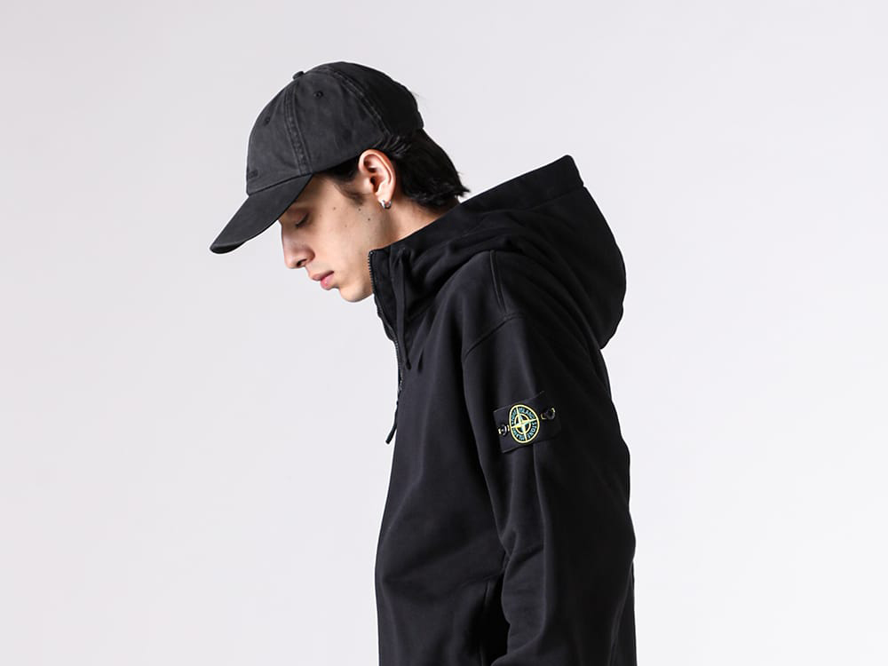 Close-up view of the embroidered logo on the STONE ISLAND cap