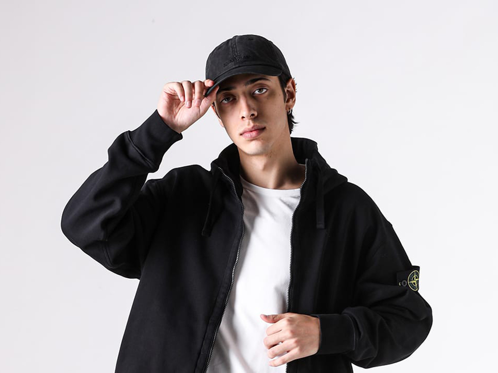 Styling image incorporating the STONE ISLAND cap and accessories