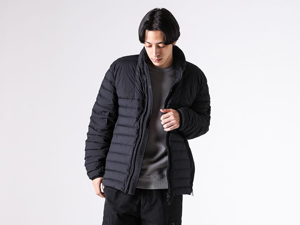 Close-up view of the fabric texture of the STONE ISLAND nylon jacket