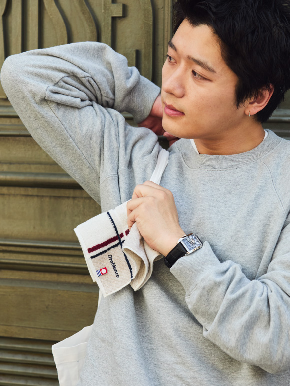ハンカチを持ちレザーベルト腕時計を身に着けた KEVIN CHEN